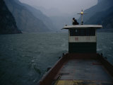 Man Changes a Lightbulb on a Barge near the Three Gorges