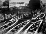 60 Ft Long  Prefabricated Bridge Trusses  Outside Where Construction Crew Add Finishing Touches