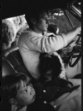 Senator Robert Kennedy Driving Car with Pet Springer Spaniel over His Lap and Son Max Beside Him
