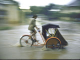 Man Driving Rickshaw During Monsoon Season