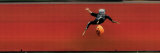 Child in Halloween Skeleton Costume Jumping in Air