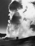 Couple Looking at Geyser Old Faithful at Yellowstone National Park