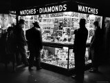 Customers Peering at the Wares Inside a Small  Brightly Lit Times Square Jewelry and Watch Shop