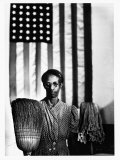 Ella Watson Standing with Broom and Mop in Front of American Flag  Part of Depression Era Survey