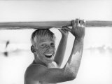 Freckled Surfer Larry Shaw Carrying Surfboard on His Head