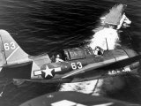 American SB2C Scout Plane Circling Above an Aircraft Carrier Prior to Landing
