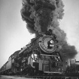 Engine Spewing Smoke as Train Proceeds En Route
