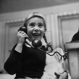Young Girl Talking to Santa Claus on the Telephone