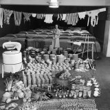 Housewife Marjorie McWeeney with Broom Amidst Display of Week's Housework at Bloomingdale's Store