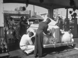 Muller Brothers Service Station's Attendants Pumping Gas and Inflating Tires on a Fancy Convertible