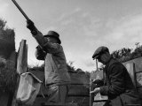 Herbert Lee Pratt Firing His Gun Toward a Grouse While the Loader Reloads Ammunition