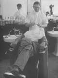 Man Receiving a Shave in a Barber Shop