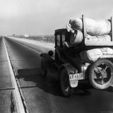 Car Laden with Baggage on Desolate Track of Highway in Desert in Southern California