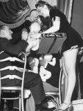 Cigarette Girl Playing with a Stuffed Animal with a Patron at the Opening of the Diamond Horseshoe