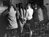 Girls Known as "Pigtailers" Sitting on Stools at Soda Fountain