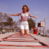 Young Woman Bouncing on Trampolines at Trampoline Center