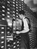 Man Looking at Film Records Containing Social Security Numbers at the Social Security Board