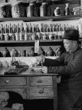 Druggist Working at Table in Drugstore