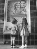 Children Looking at Posters Outside Movie Theater
