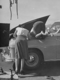 Girl Attendant Looking For Battery For Customer