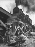 Gi Infantry Guards Keeping Warm by a Fire Next to an Army Engineer Built Railroad Bridge