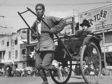 Heavily Loaded Rickshaws and Pedicabs Crowd the Streets