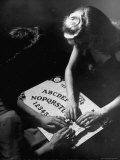 People Playing with a Ouija Board