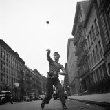Young Boy Pitching Ball on a City Street