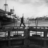 Man Walking Across Gateway Leading from Bramley Moore Dock Into Sanden Half Tide Dock