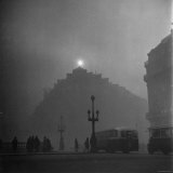 People and Vehicles Moving About City Shrouded in Fog