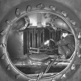 Welder with an Acetylene Torch Cutting Through Some of the Old Tubes in a Modern Locomotive