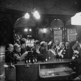 Patrons Drinking and Chatting at the Bar of a Music Hall