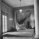 The Entrance Hall and Stair Well with Walls Hung with Pictures