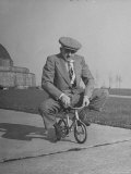 Humorous of Man Riding Tiny Bicycle