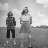 Teenage Twin Girls Standing in Field