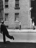 Boy Hitting Ball During Game of Stickball