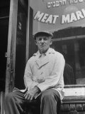 Butcher Taking a Break  Sitting in Front of Meat Market