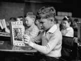 Child Reading a Book in School