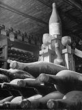Dust Covered Wine and Brandy Bottles Lying on Racks in a Wine Cellar