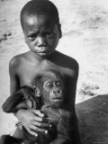 Local Tribe Youngster Holding a Baby Gorilla Names Bobo After the Hunting Exhibition
