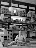 Butcher Standing at Meat Counter of Deli