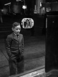 Boy Watching TV on Store Window Set  Glass Reflects the Image Off TV Screen