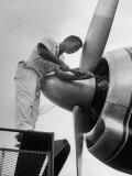 Eastern Airline Employees Working on the Maintaining an Aircraft's Engine
