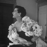 Model Wearing a Flowery Dress While Peering Into the Distance