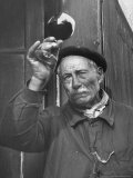 French Man Looking at How Clear the Wine Is