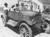 African American Men and a Boy in Dusty Jalopy in Front of Clapboard Church