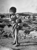 Girl Standing in Rubble from the Korean Civil War  Carrying a Baby in a Sling on Her Back