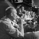 Men Gathered Around For Their Weekly Meeting Indulging in Glasses of Beer