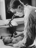 Intern at Minneapolis General Hospital Listening with Stethoscope to Newborn Baby's Heartbeat
