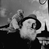 Old German Circus Artist Nikolaus Munz with His Pet Monkey  Waiting to Board a Small Ferry